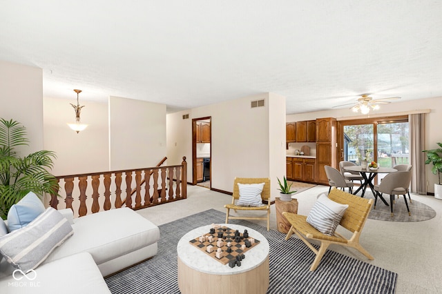 living room with light carpet and ceiling fan