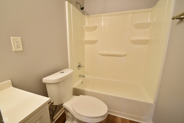 full bathroom featuring washtub / shower combination, hardwood / wood-style floors, vanity, and toilet