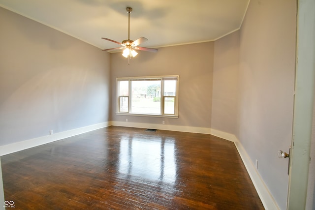 unfurnished room featuring ceiling fan, dark hardwood / wood-style flooring, and crown molding