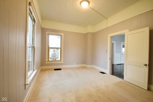 carpeted empty room with ornamental molding