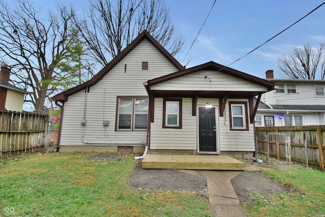 back of house featuring a yard