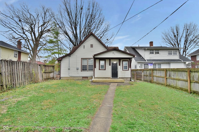 rear view of property featuring a lawn