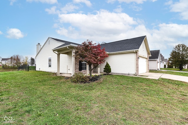 view of front of home with a garage and a front lawn