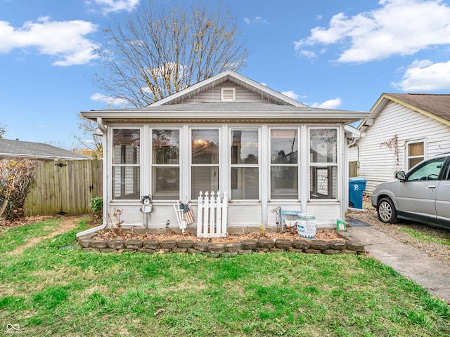 exterior space featuring a sunroom and a yard