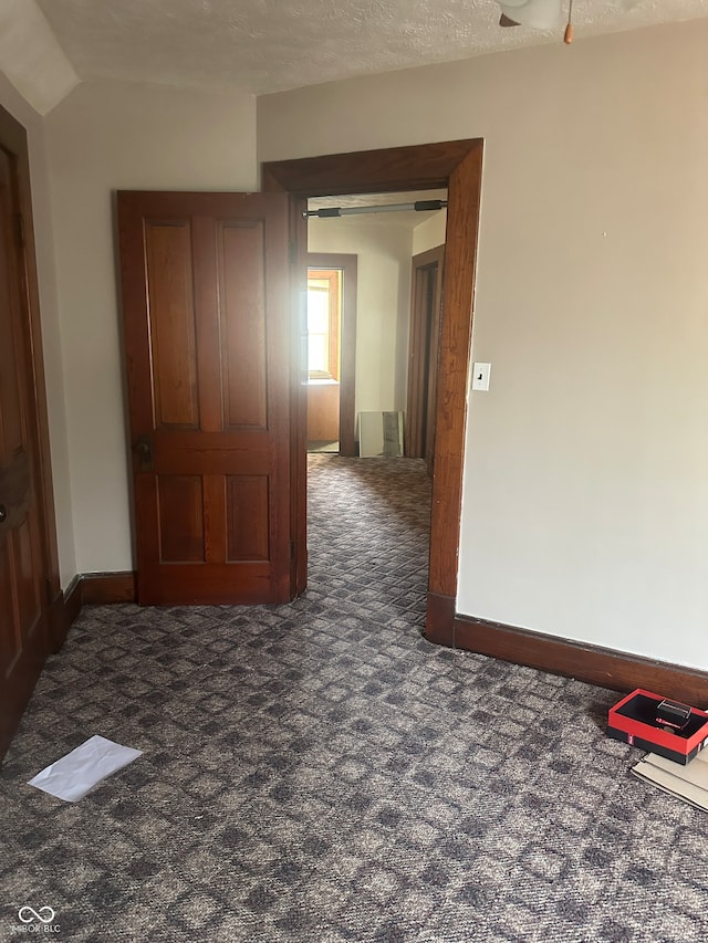 carpeted spare room featuring a textured ceiling