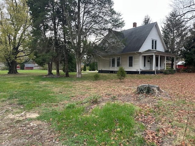 view of property exterior featuring a yard and covered porch