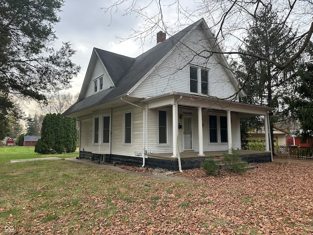 view of front of house featuring a front yard and a porch