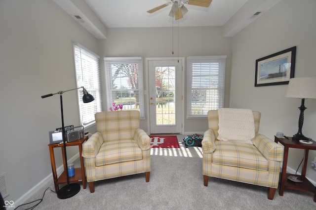 sitting room with ceiling fan, carpet, and a healthy amount of sunlight