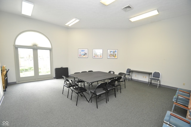 dining area featuring dark colored carpet