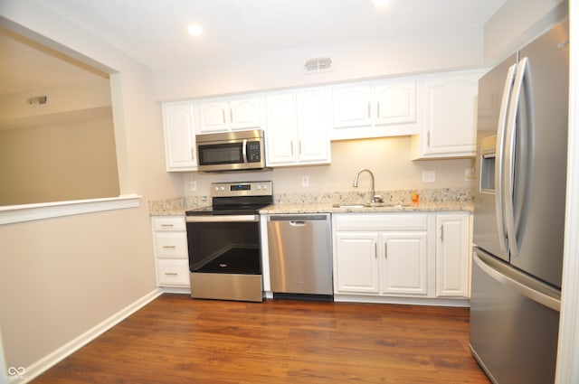 kitchen with dark hardwood / wood-style flooring, sink, white cabinets, and appliances with stainless steel finishes