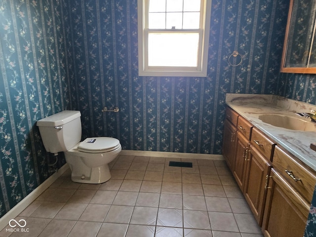 bathroom featuring vanity, toilet, and tile patterned flooring