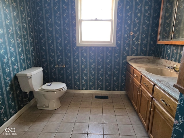 bathroom with vanity, toilet, and tile patterned floors