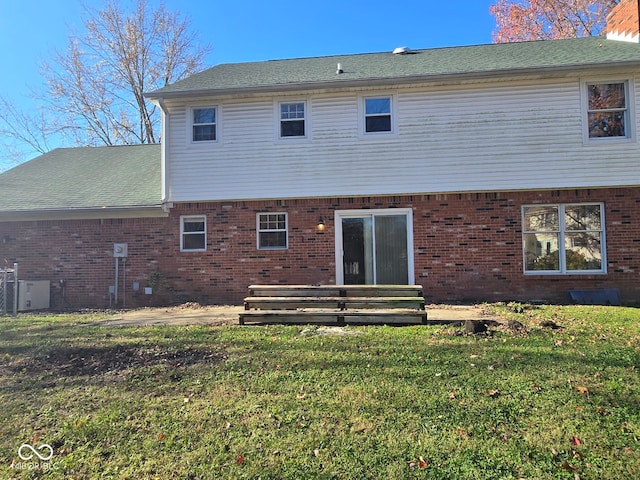 rear view of property with a lawn