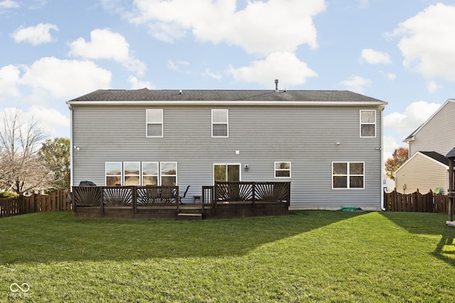 back of house featuring a yard and a deck