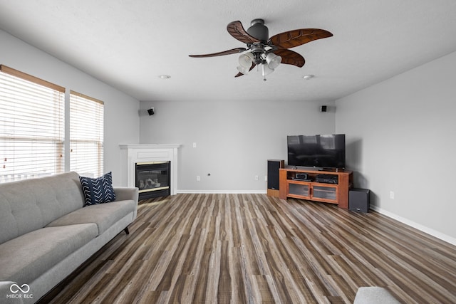 living room featuring a textured ceiling, dark hardwood / wood-style flooring, and ceiling fan