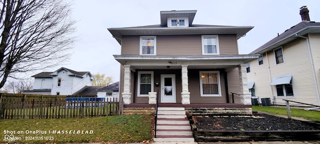 view of front of property with covered porch and central AC unit