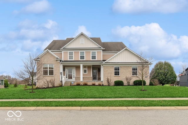 view of front of home with covered porch and a front yard