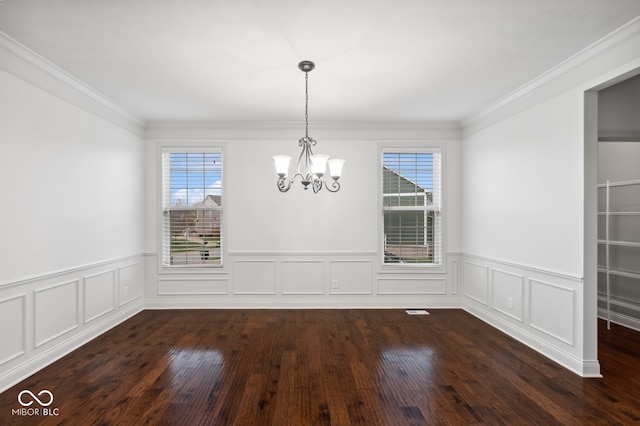 unfurnished dining area with crown molding, a chandelier, and dark hardwood / wood-style floors