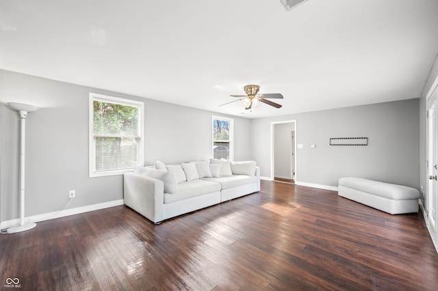 unfurnished living room with a wealth of natural light, dark hardwood / wood-style flooring, and ceiling fan