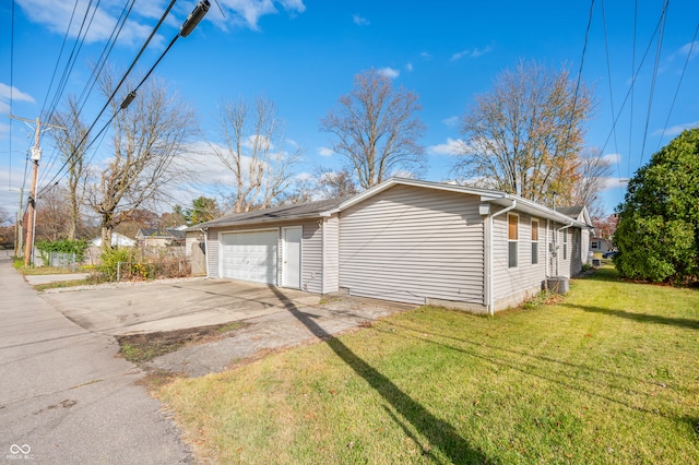 view of side of property featuring central air condition unit, a garage, and a lawn