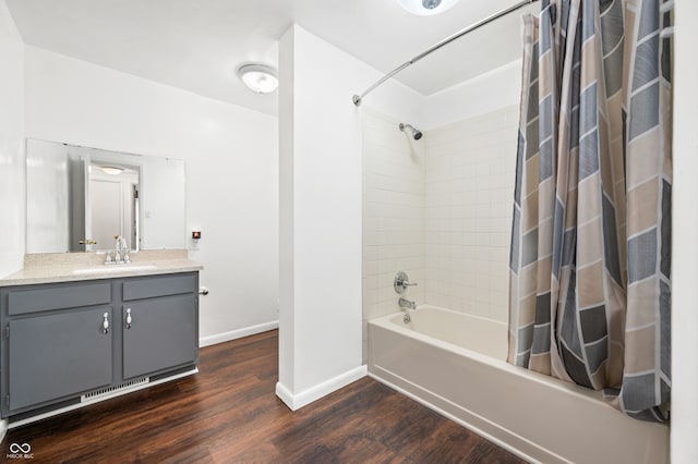 bathroom with hardwood / wood-style floors, vanity, and shower / bath combination with curtain