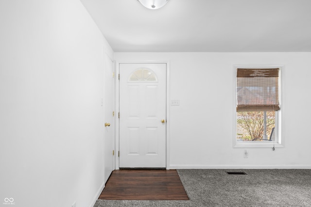 entryway with dark hardwood / wood-style flooring