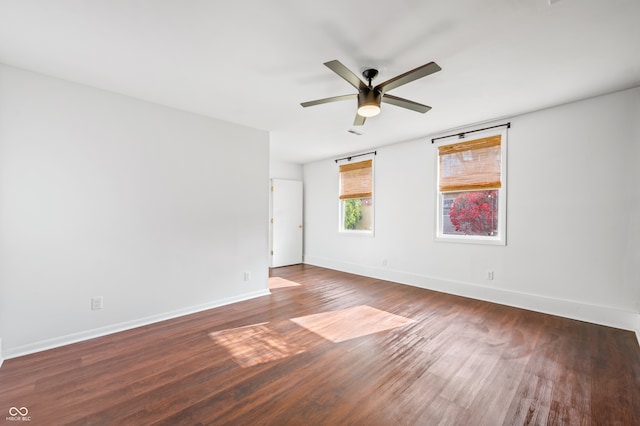 spare room with ceiling fan and dark wood-type flooring