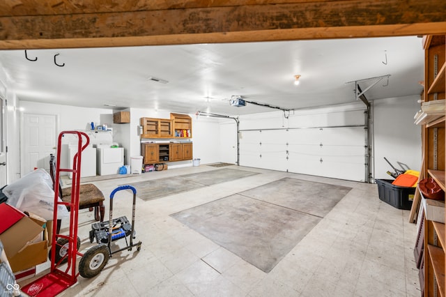 garage featuring a garage door opener and washer and clothes dryer