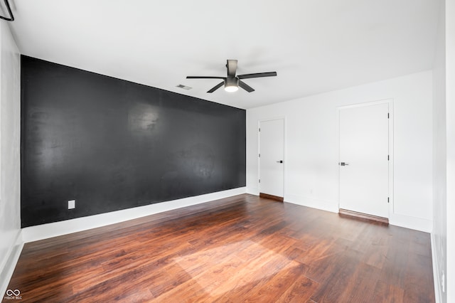 spare room with ceiling fan and dark hardwood / wood-style flooring