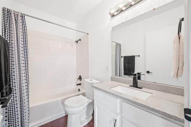 full bathroom with hardwood / wood-style flooring, vanity, toilet, and shower / tub combo