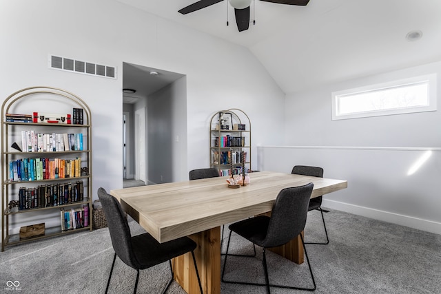 carpeted dining area with vaulted ceiling and ceiling fan