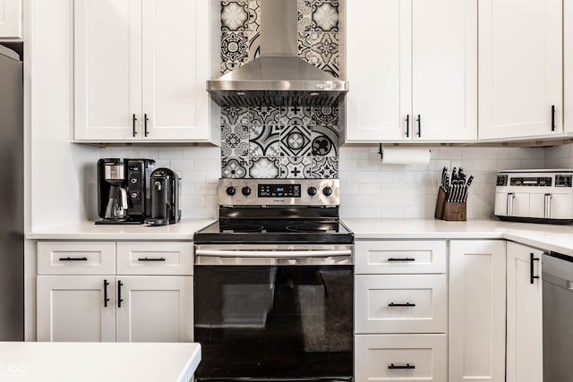 kitchen with appliances with stainless steel finishes, white cabinetry, and wall chimney exhaust hood