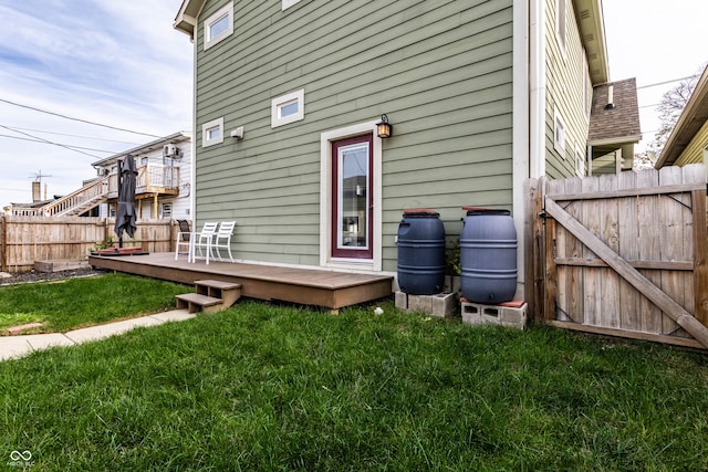 rear view of property with a yard and a deck