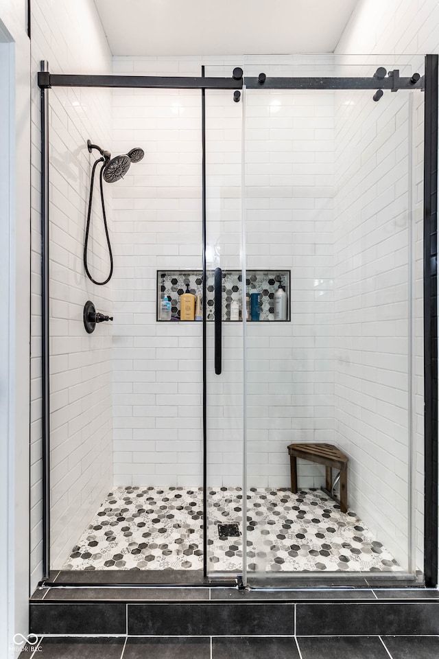 bathroom with tile patterned flooring and walk in shower