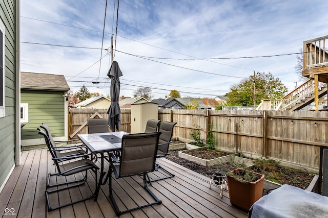 wooden terrace featuring a storage unit