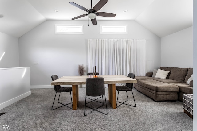 carpeted dining space featuring ceiling fan and vaulted ceiling