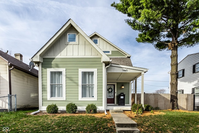 view of front of property with a front yard and a porch