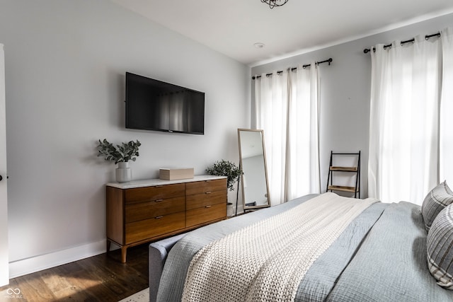 bedroom with dark wood-type flooring