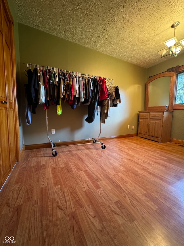 interior space featuring light hardwood / wood-style flooring and a textured ceiling