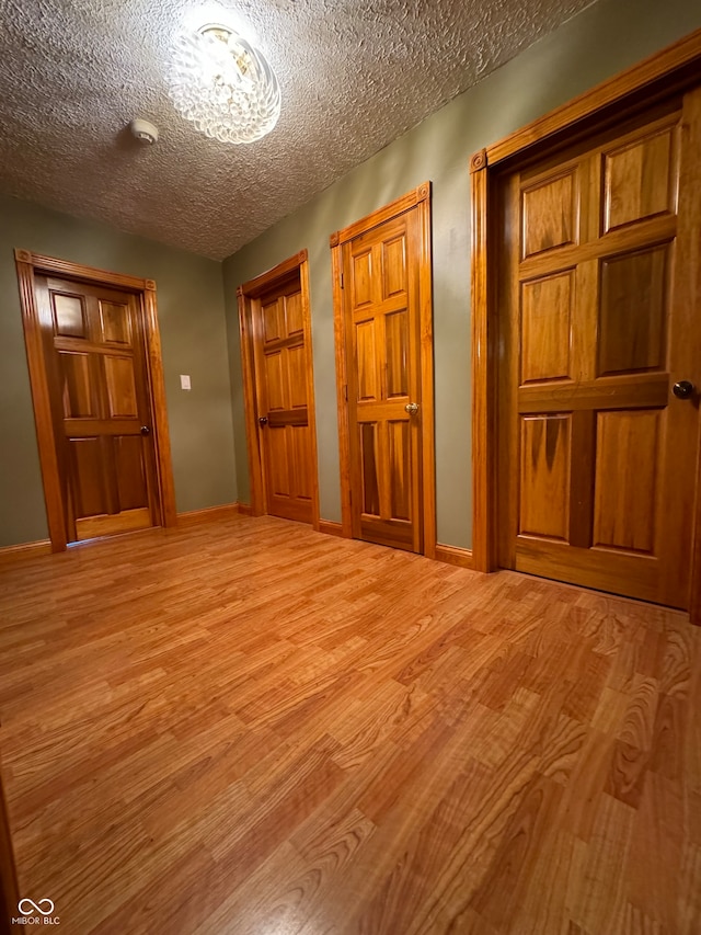 interior space featuring light hardwood / wood-style floors and a textured ceiling