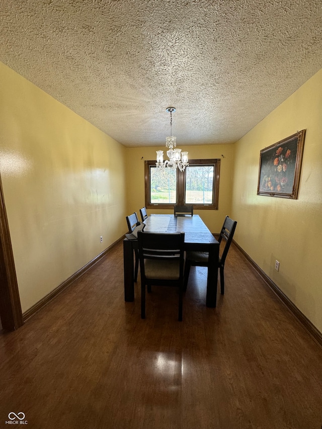 dining space with dark hardwood / wood-style flooring, a textured ceiling, and an inviting chandelier