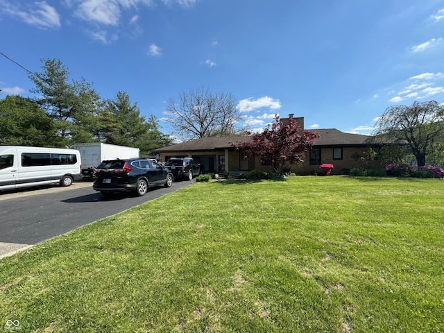 view of front of property with a garage and a front lawn