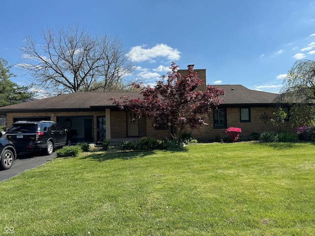 view of front of house with a front yard and a garage