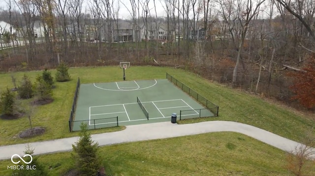 view of basketball court with a lawn