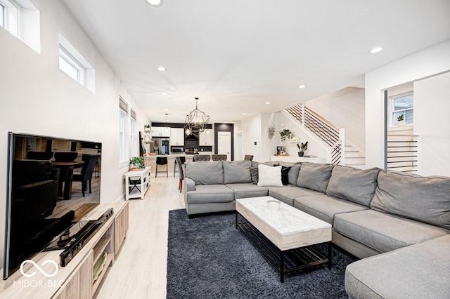 living room featuring light hardwood / wood-style flooring and a chandelier