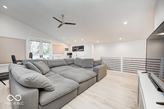 living room with ceiling fan, light wood-type flooring, and high vaulted ceiling