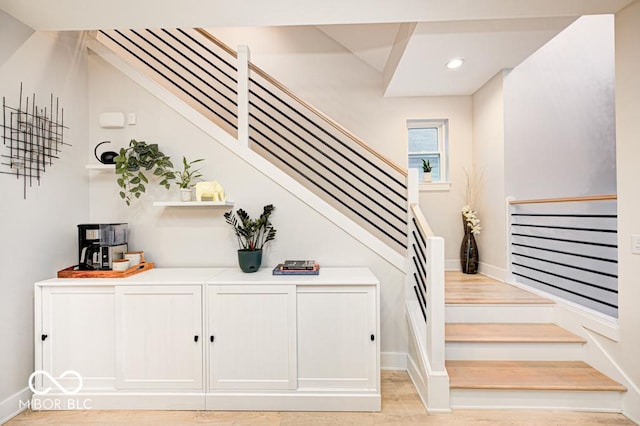 stairway featuring hardwood / wood-style flooring