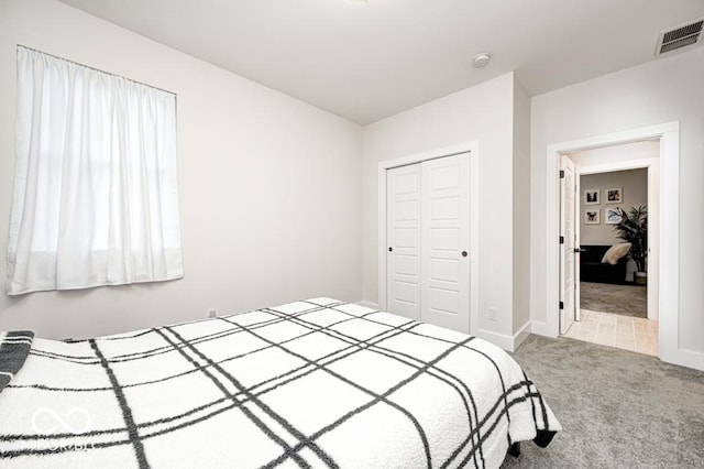 carpeted bedroom with a closet