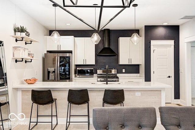 kitchen with sink, white cabinets, stainless steel appliances, and extractor fan