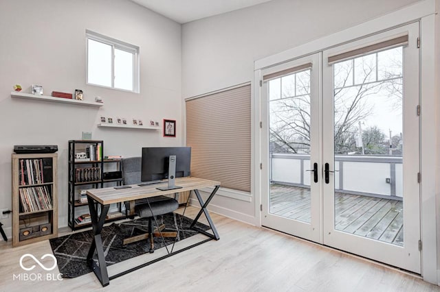 office area with hardwood / wood-style floors and french doors